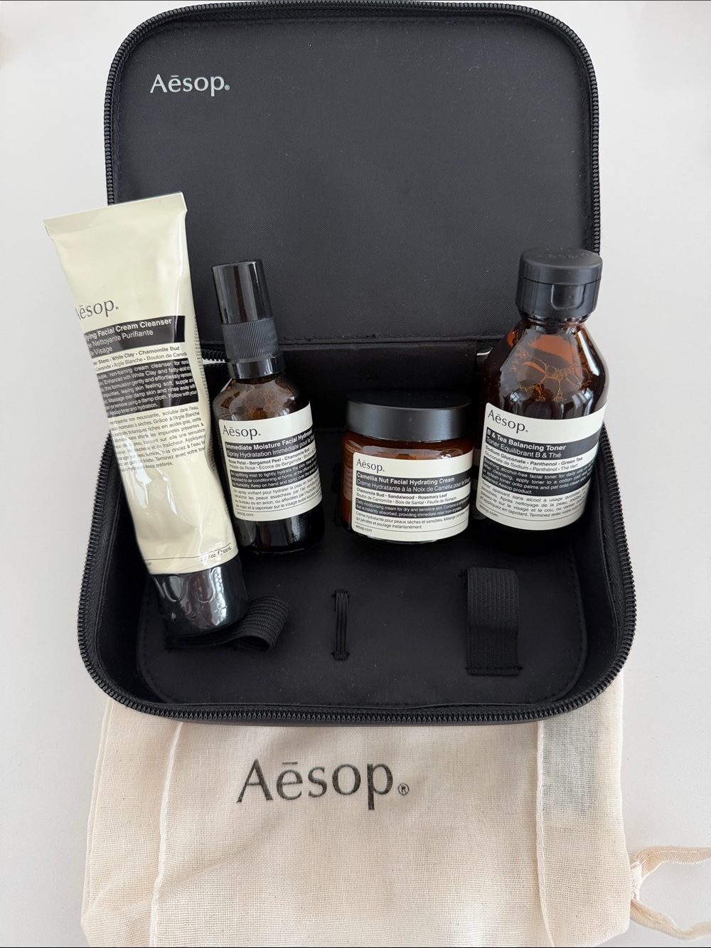 Aēsop Unisex Skincare Travel Kit – Black Case with Cream & Amber Bottles